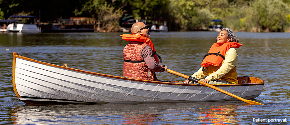 A man and a woman in a boat enjoying a nice day.