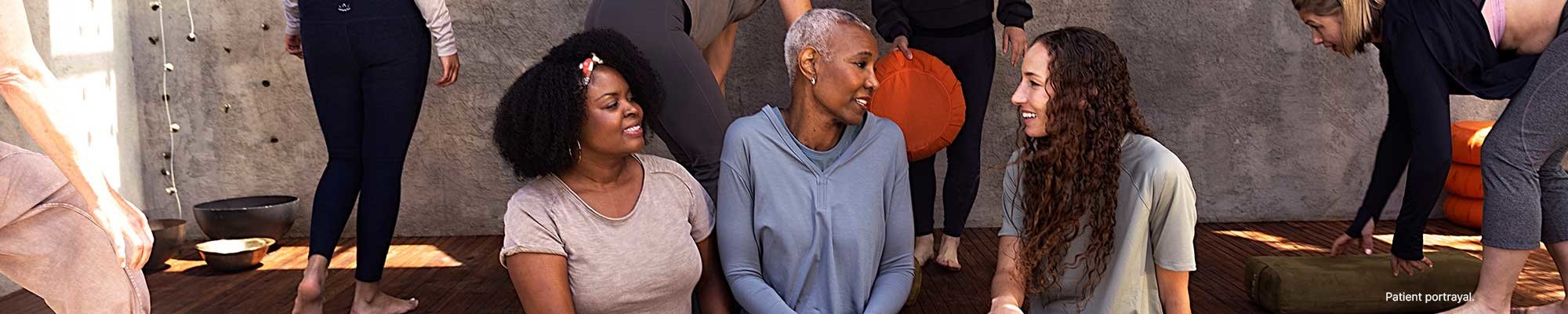 Women sitting together outside after a yoga class.