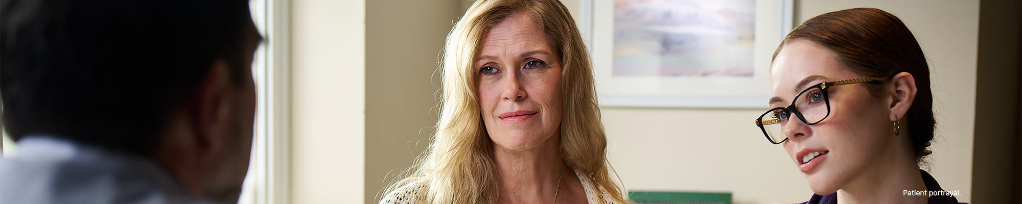 Two women having a conversation with a doctor.